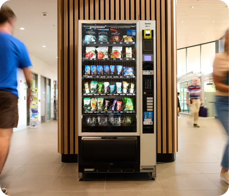 Modern vending machine stocked with snacks and cold drinks in an office building